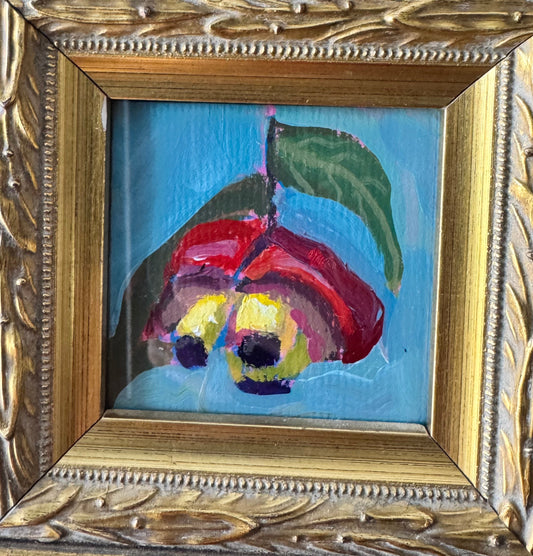 A small framed painting featuring a stylized red flower with a green leaf on a light blue background, set within an ornate gold-toned carved frame.