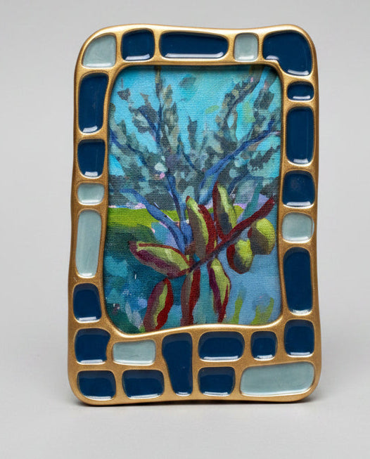 Rectangular mosaic art piece with blue and gold frame on a gray background