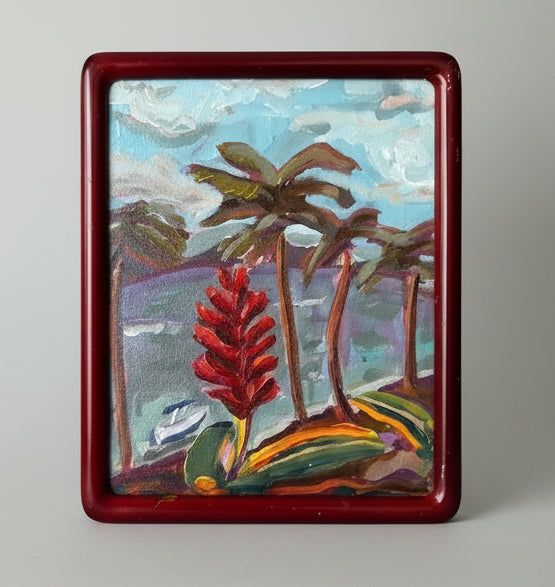 Framed painting of tropical landscape with palm trees and red flower.