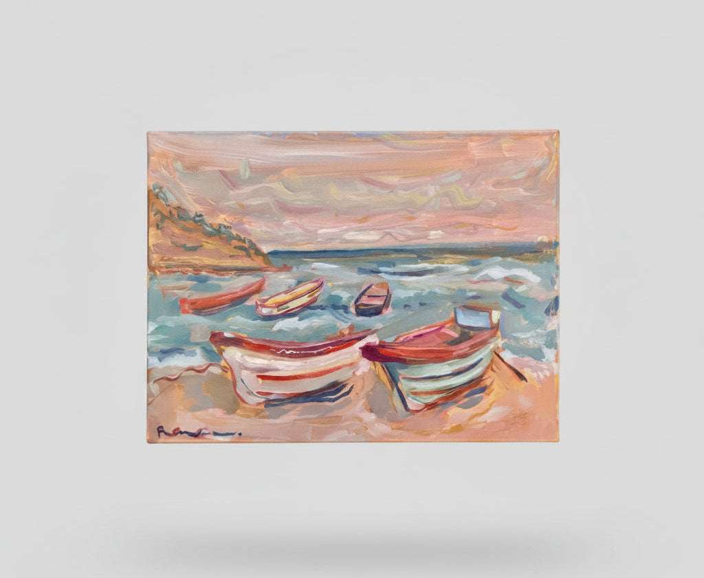 A hand holds a square canvas painting of several small boats on a pink and blue sea under a cloudy sky, photographed in a real indoor room with furniture and stairs visible in the background.