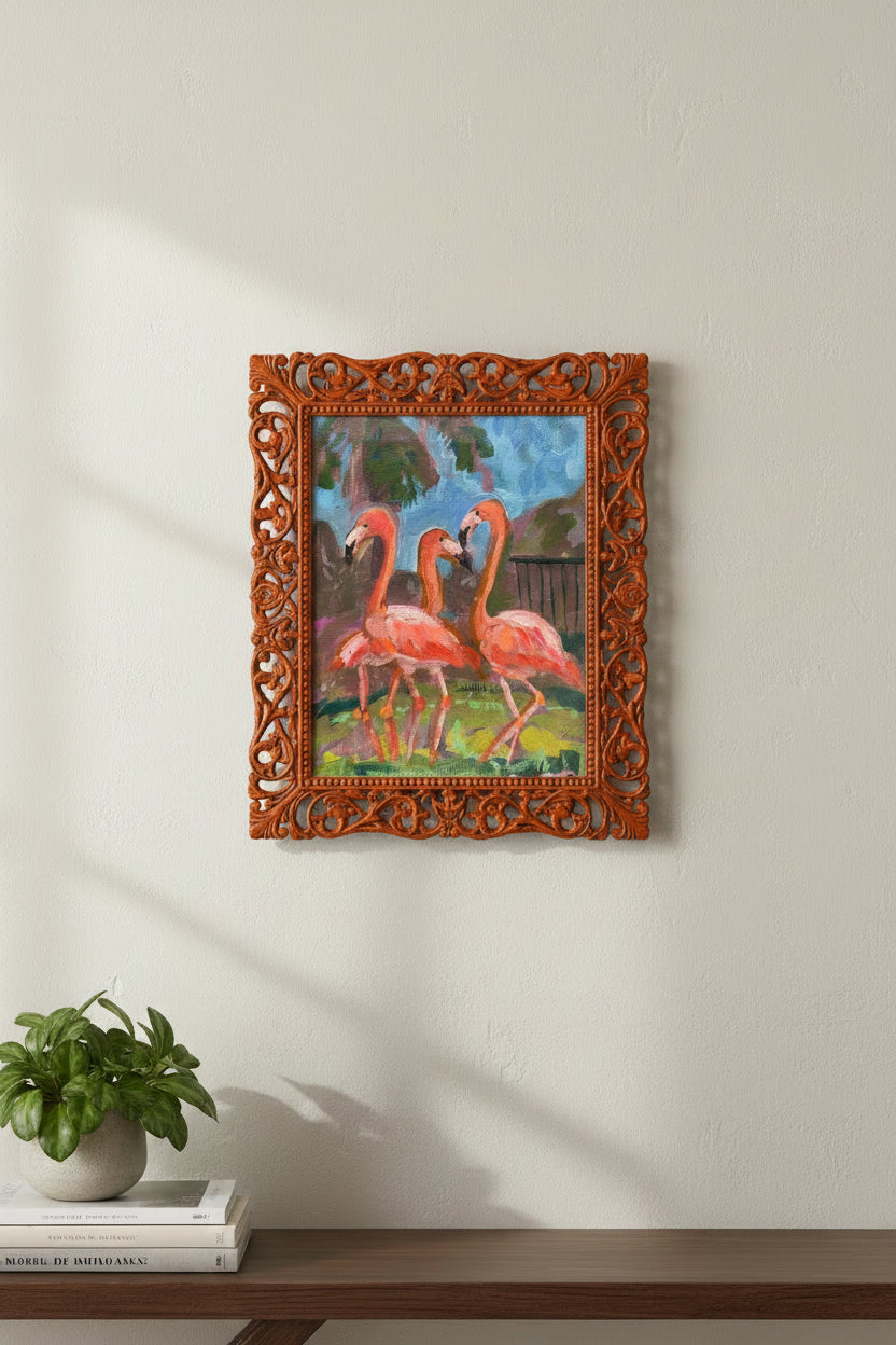 Three pink flamingos in a natural setting with greenery and water.