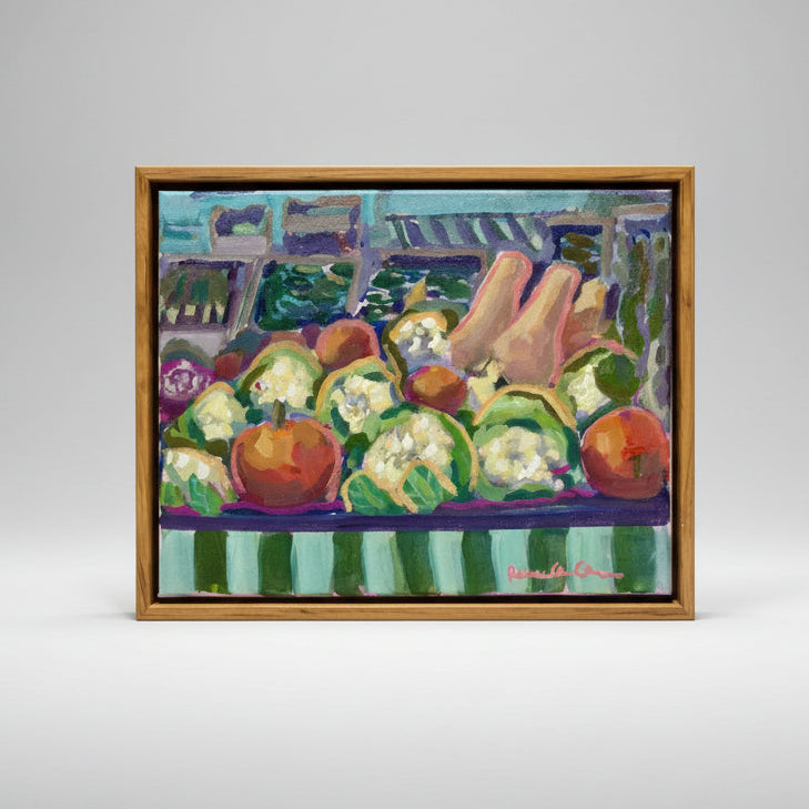 Colorful painting of vegetables on a table with a light wood frame