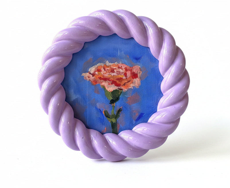 Decorative plate with a purple rim featuring a rose design on a white background