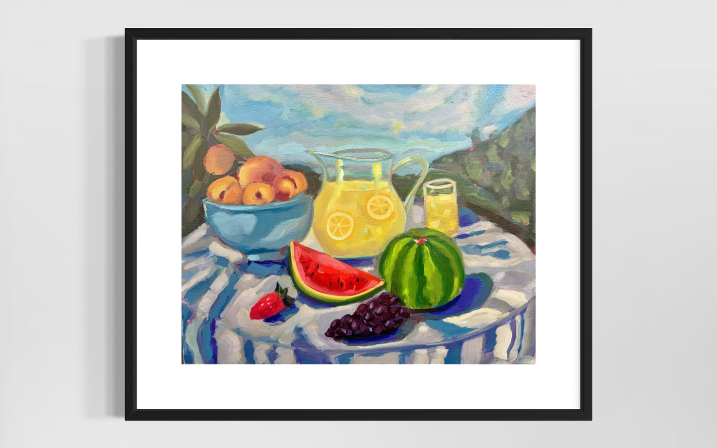 Framed painting of a still life with fruits and a pitcher on a striped tablecloth.