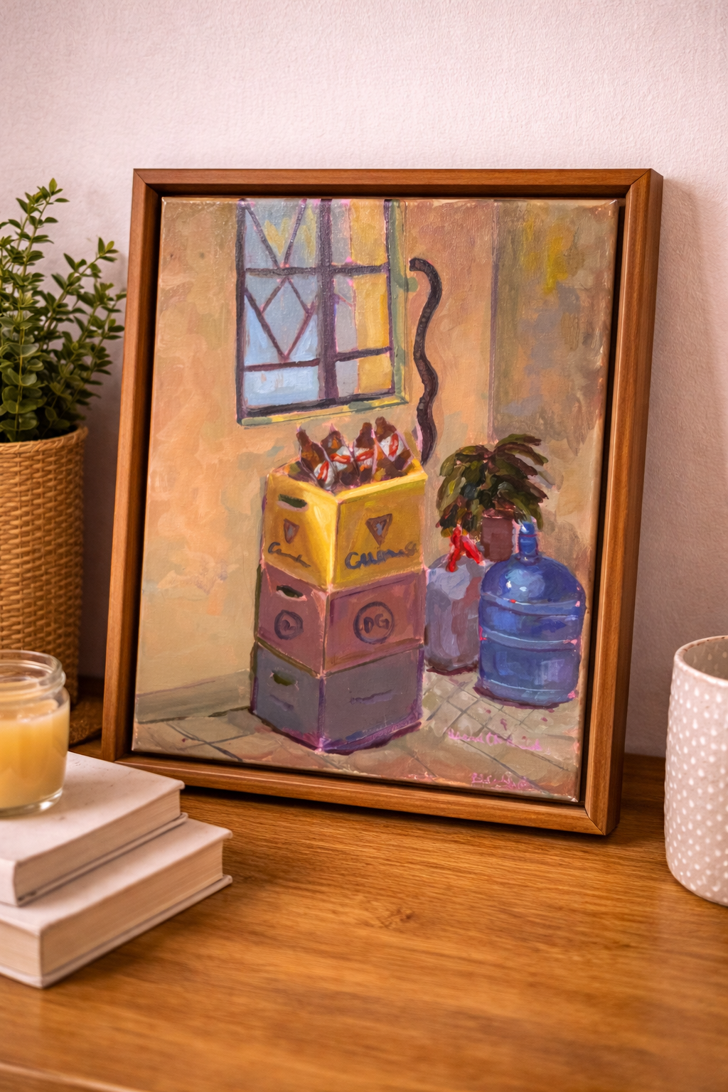 Framed painting of stacked plastic containers on a wooden surface with books and a candle.